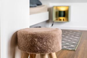 a brown stool sitting in a living room at Fewo Parkside S5 - 8Min Legoland in Günzburg