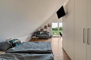 a living room with a bed and a couch at Fewo Parkside S5 - 8Min Legoland in Günzburg