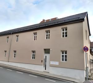 a white building on the side of a street at C & D Wohnung I in Bad Kissingen