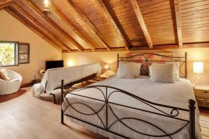 a bedroom with a bed and a chair in a room at The Perfect Cottage in São Vicente