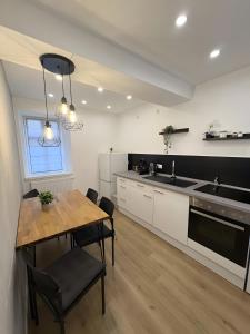 a kitchen with a wooden table and a dining room at C & D Wohnung I in Bad Kissingen
