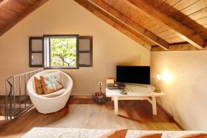 a room with a chair and a desk with a computer at The Perfect Cottage in São Vicente