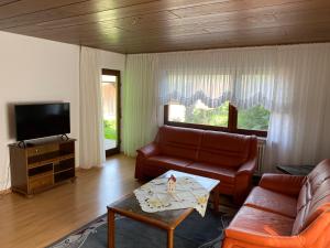 a living room with a couch and a tv at Ferienwohnung Josefa Ganter 80qm in Ühlingen-Birkendorf