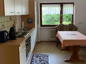a small kitchen with a table and a window at Ferienwohnung Josefa Ganter 80qm in Ühlingen-Birkendorf