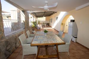a dining room with a table and chairs on a balcony at La Casita in San Vicente del Raspeig