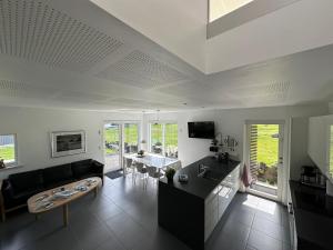 a living room with a couch and a table at Luxury Cottage with Stunning Views - Okkara summarhús við Gjógv in Við Gjógv