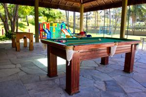 a pool table in front of a playground at FLAT MARULHOS SUÍTES E RESORT in Porto De Galinhas