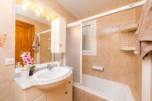 a bathroom with a sink and a bath tub at Es Pujol in Alcudia +19 photos