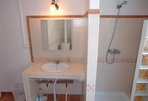 a bathroom with a sink and a mirror and a tub at Townhouse Almunecar Old Town in Almuñécar +19 photos