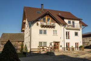 a large white house with a brown roof at Ferienhof Sauter Friedrichshafen in Neukirch