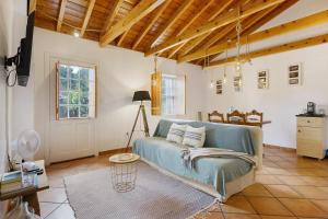 a living room with a blue couch and a table at Adega Peróla in Cais do Galego