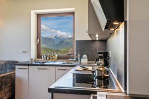 a kitchen with a view of a mountain at Gatscherhof Apt Abendrot in Luson