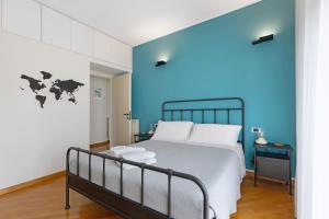 a bedroom with a bed with a blue wall at Casa vacanze Brezza di Levante in Sestri Levante