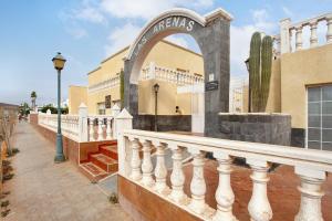 a balcony of a building with an archway at Casa Yeray in Caleta De Fuste