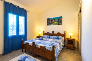 a bedroom with a bed and a window at Villa Alba in Costa Paradiso