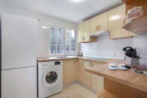 a kitchen with a washer and dryer in it at Casa Yeray in Caleta De Fuste