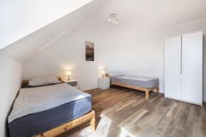 a bedroom with a bed and a bench in a room at Ferienwohnung Krautsand in Drochtersen