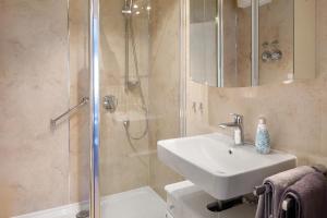 a bathroom with a sink and a shower at Oskar im Bärenhüsli in Titisee-Neustadt +35 photos