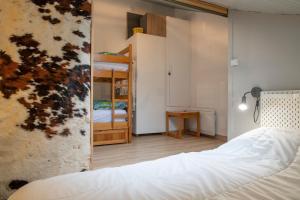 a bedroom with a bed and two bunk beds at Cosy Studio Mezzanine in Allevard
