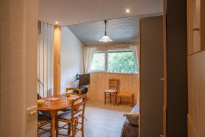 a room with a table and a dining room at Cosy Studio Mezzanine in Allevard +15 photos