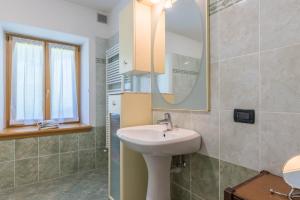 a bathroom with a sink and a mirror at Baita Serpillo in Palù del Fersina +25 photos