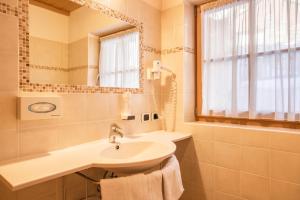 a bathroom with a sink and a mirror at App Lisüra Cir in Corvara in Badia +22 photos