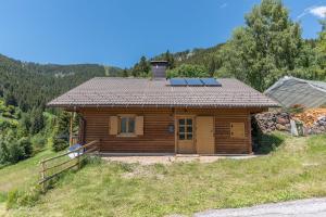 a log cabin with solar panels on the roof at Baita Serpillo in Palù del Fersina