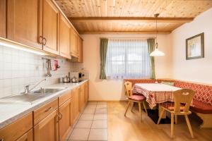 a kitchen with a table and a dining room at App Lisüra Cir in Corvara in Badia