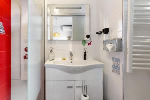 a white bathroom with a sink and a mirror at Sissi Lanço Sea View 7 in Funchal +22 photos