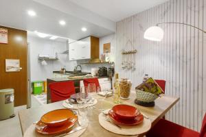 a kitchen with a table with plates and glasses on it at Sissi Lanço Sea View 7 in Funchal