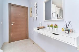 a kitchen with a white counter and a wooden door at Recreo 10 in Torrox +19 photos