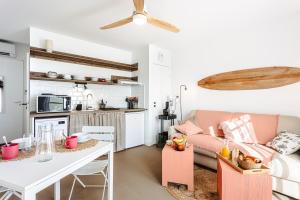 a living room with a couch and a table at Les Pins, Rivedoux Beach House in Rivedoux-Plage