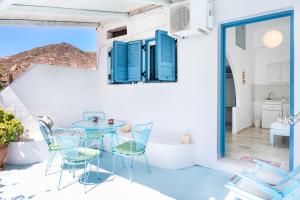 a room with a table and chairs on a balcony at Beachfront Lampis Dolphin 4 in Skala