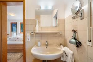 a bathroom with a sink and a mirror at Pension Schneider in Freiamt +75 photos