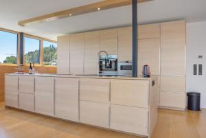 a kitchen with white cabinets and a counter top at Ferienwohnung Böhler in Doren
