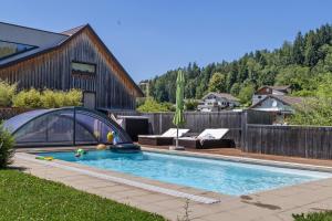 a swimming pool in the yard of a house at Ferienwohnung Böhler in Doren