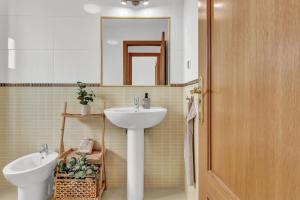 a bathroom with a sink and a toilet and a mirror at Villa Manuela in Lajares +22 photos