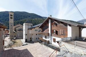 a view of a building with a clock tower at Baita Del Canton in Valdidentro