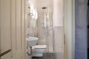 a bathroom with a toilet and a shower and a sink at Villa Stanga in Sedico +22 photos