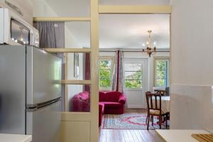 a kitchen with a refrigerator and a dining room at Villa Stanga in Sedico