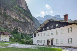 a white house in front of a mountain at Villa Stanga in Sedico