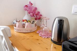 a table with a coffee maker and flowers on it at La Rosa Dei Venti in Vernazza