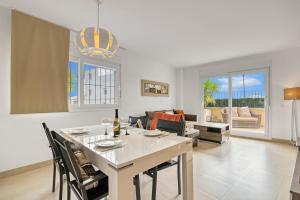 a kitchen and living room with a table and chairs at Amanda in Jávea