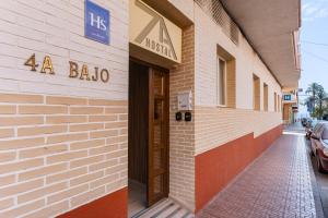 a building with aania sign on the side of it at 7A Hostal in Torrevieja