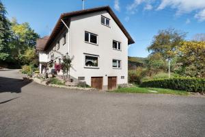 a white house on the side of a road at Pension Schneider in Freiamt
