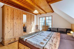 a bedroom with a large bed and a large window at Wanglerhof Familie Wangler in Schuttertal