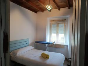 a bedroom with a bed and a blue table at Casa Adelina in Foz