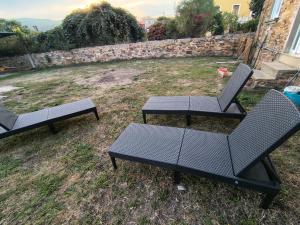 three picnic tables and chairs in a yard at Casa Adelina in Foz