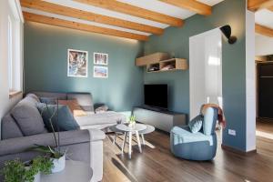 a living room with a couch and a tv at La Maison du Renard in Sarre