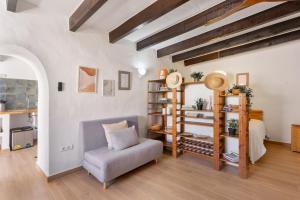 a living room with a chair and a bed at Can Vital 2 in Illes Balears